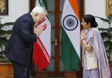 India's Foreign Minister Swaraj and her Iranian counterpart Zarif fold their hands in a traditional Indian greeting before their meeting in New Delhi